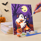 Painting a Cozy Autumn Spooks mini canvas propped up beside numbered acrylic paints