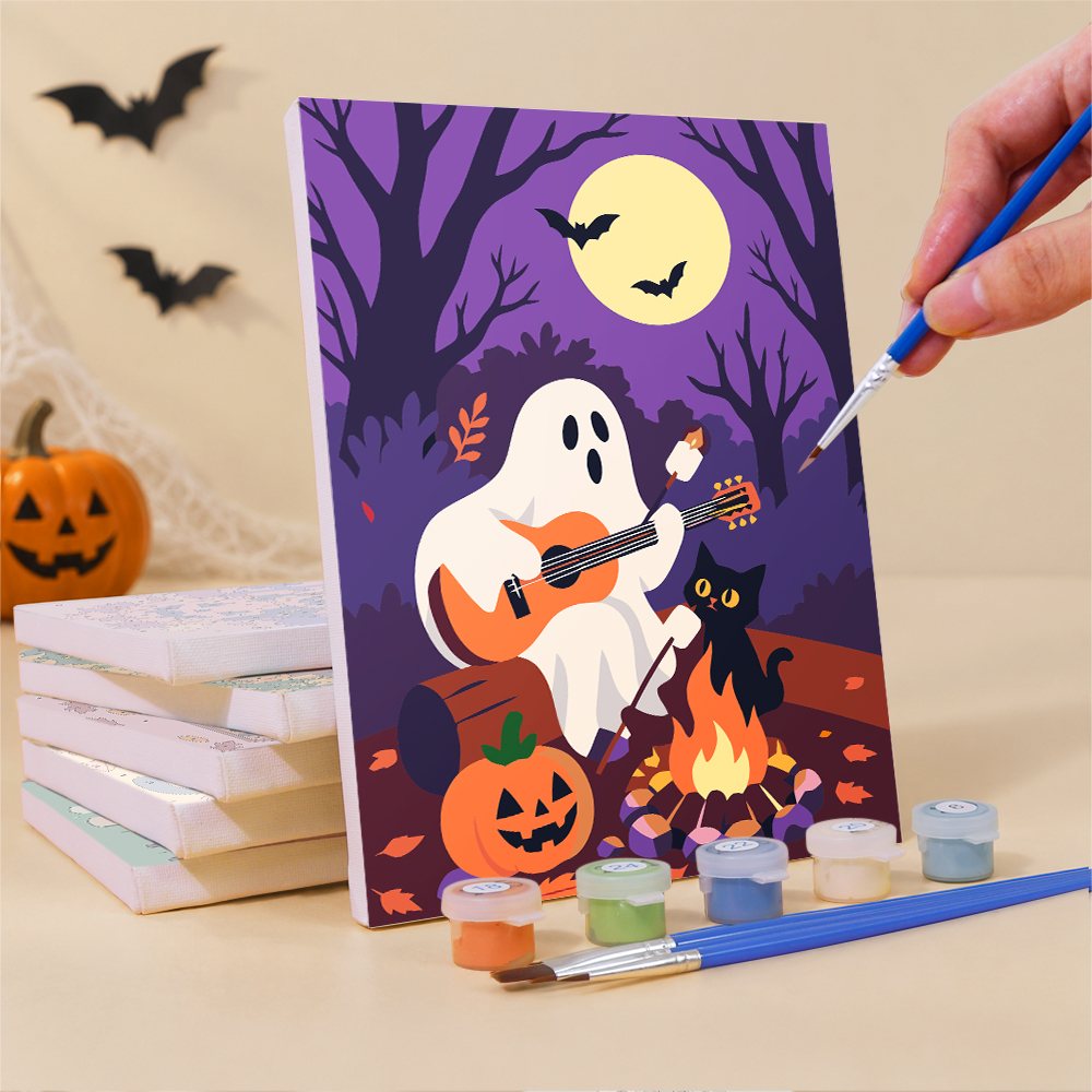 Painting a Cozy Autumn Spooks mini canvas propped up beside numbered acrylic paints