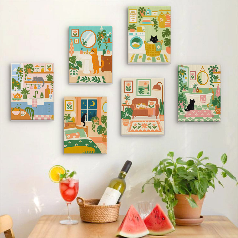 Six finished Cozy Cat Home mini paintings hung on a wall above a table