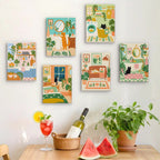 Six finished Cozy Cat Home mini paintings hung on a wall above a table