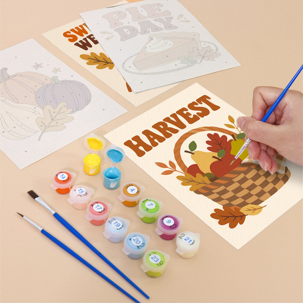 Filling in a Cozy Fall mini canvas with numbered acrylic paints and a fine brush
