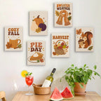Six finished Cozy Fall mini paintings hung on a wall above a table