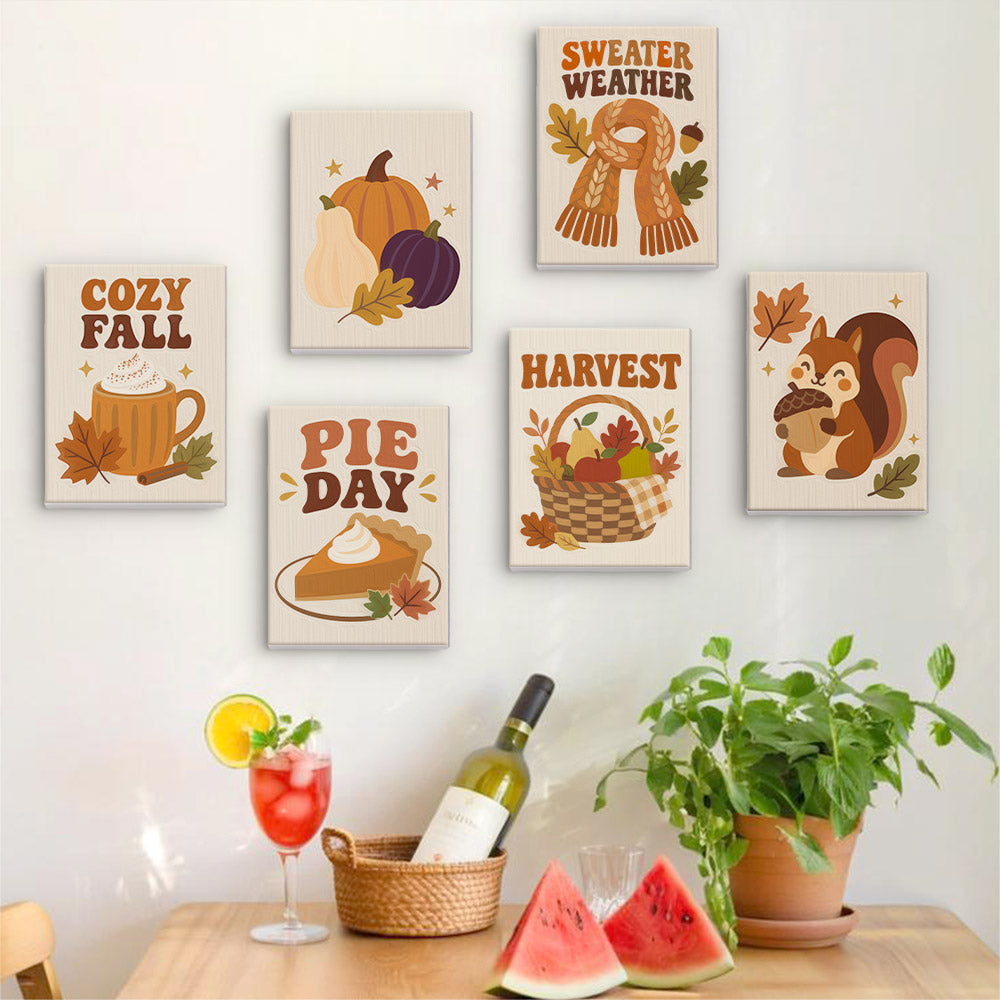 Six finished Cozy Fall mini paintings hung on a wall above a table