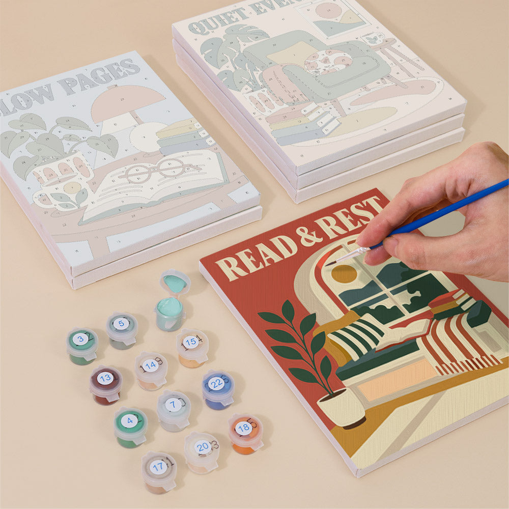 Painting one of the Cozy Reading Nook designs next to a stack of mini canvases