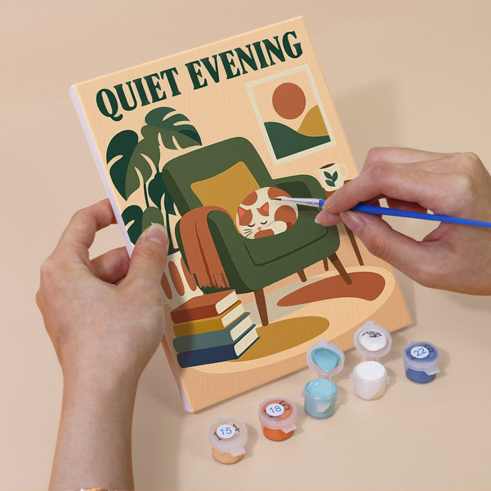Hand holding a Cozy Reading Nook mini canvas while painting the details