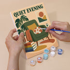 Hand holding a Cozy Reading Nook mini canvas while painting the details