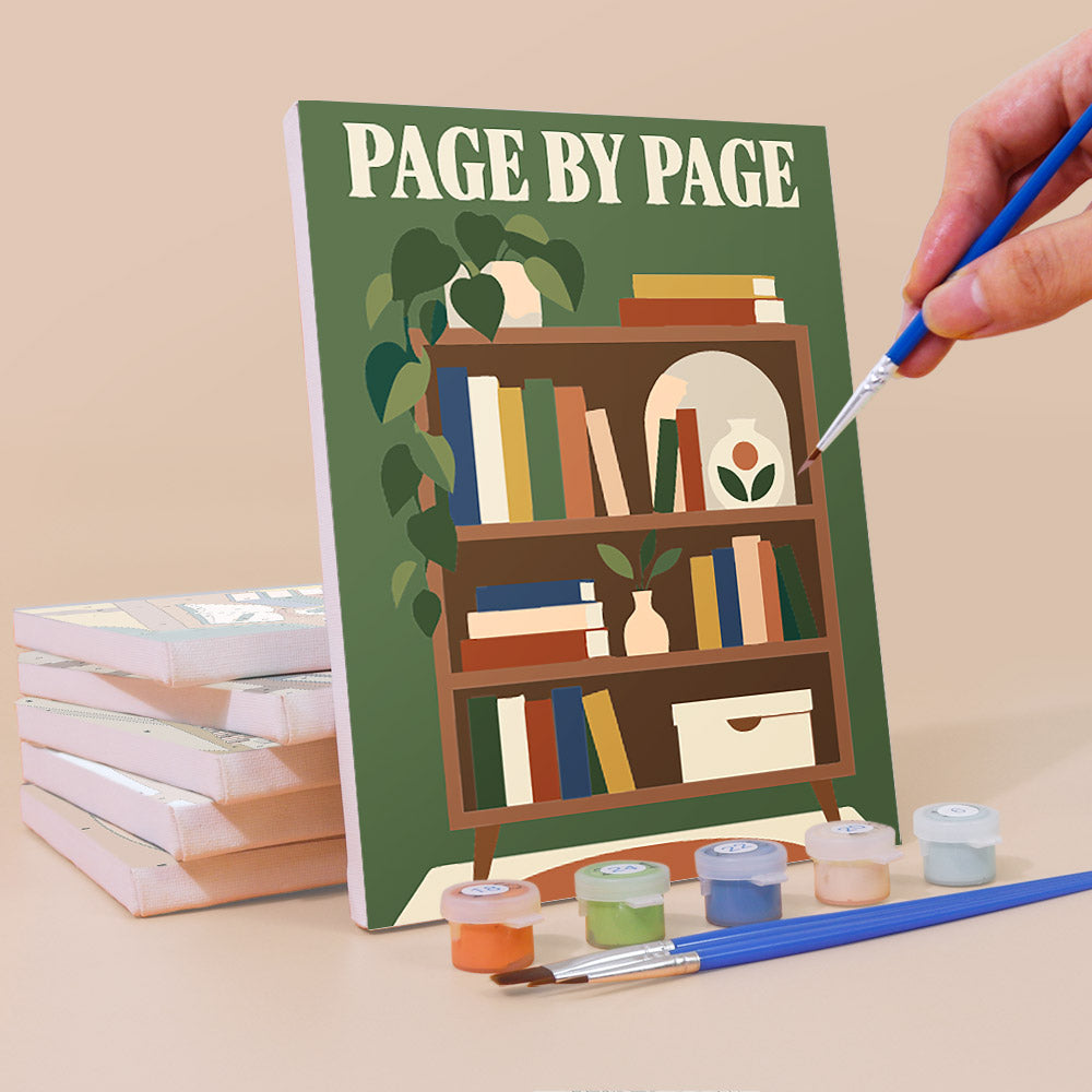 Painting a Cozy Reading Nook mini canvas propped up beside numbered acrylic paints
