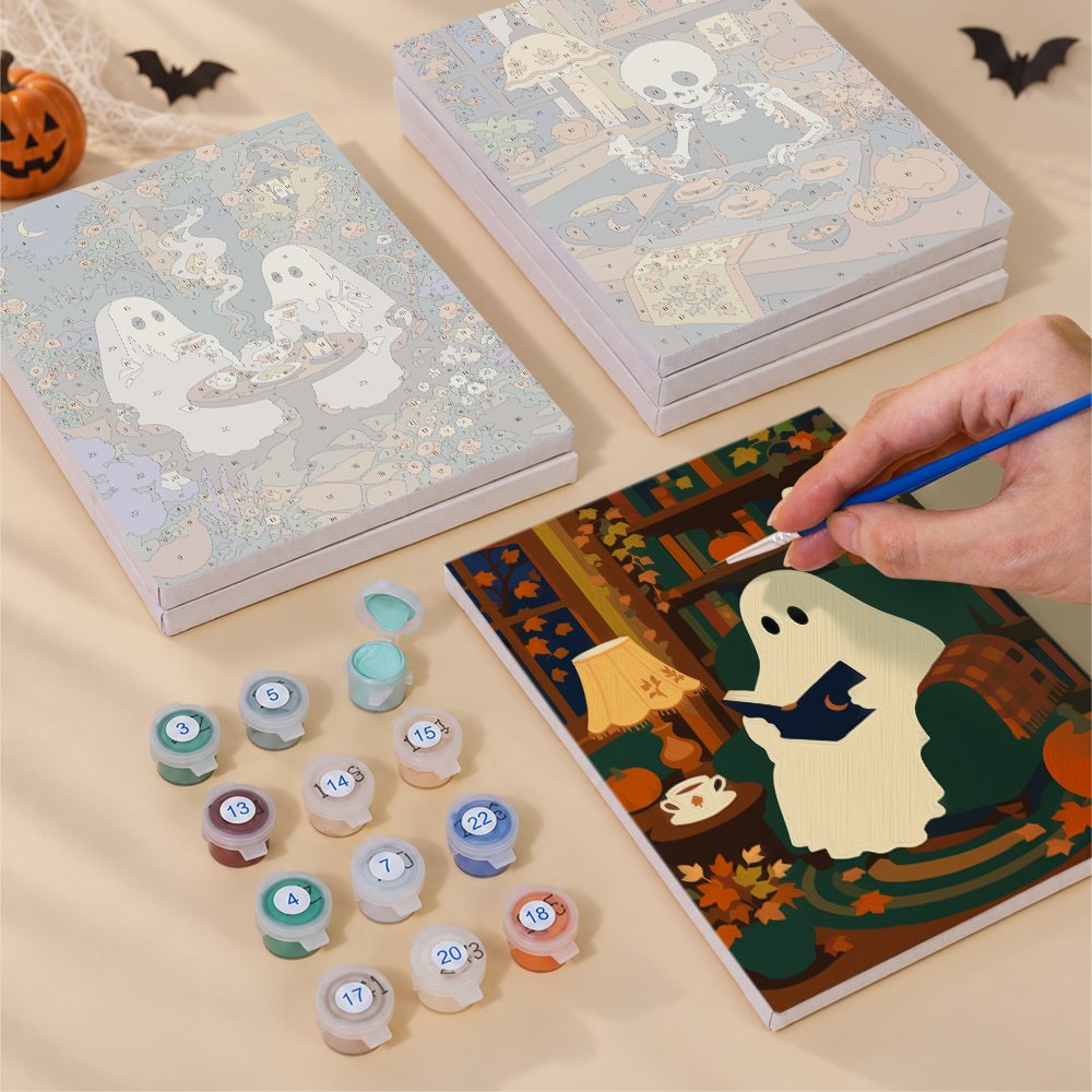 Painting one of the Cozy Witch Cottage designs next to a stack of mini canvases