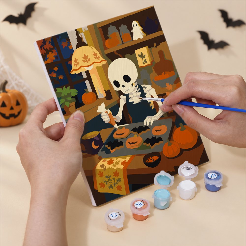 Hand holding a Cozy Witch Cottage mini canvas while painting the details