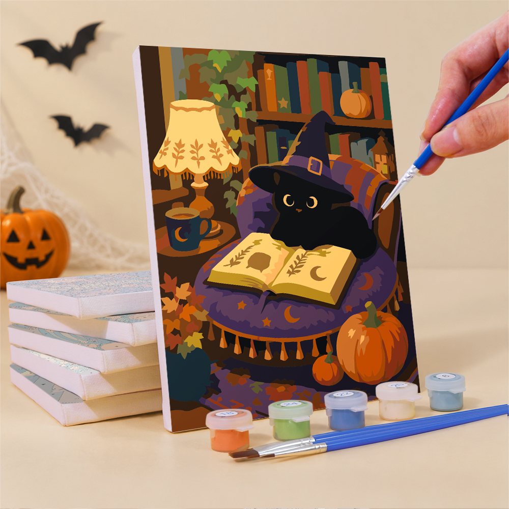 Painting a Cozy Witch Cottage mini canvas propped up beside numbered acrylic paints