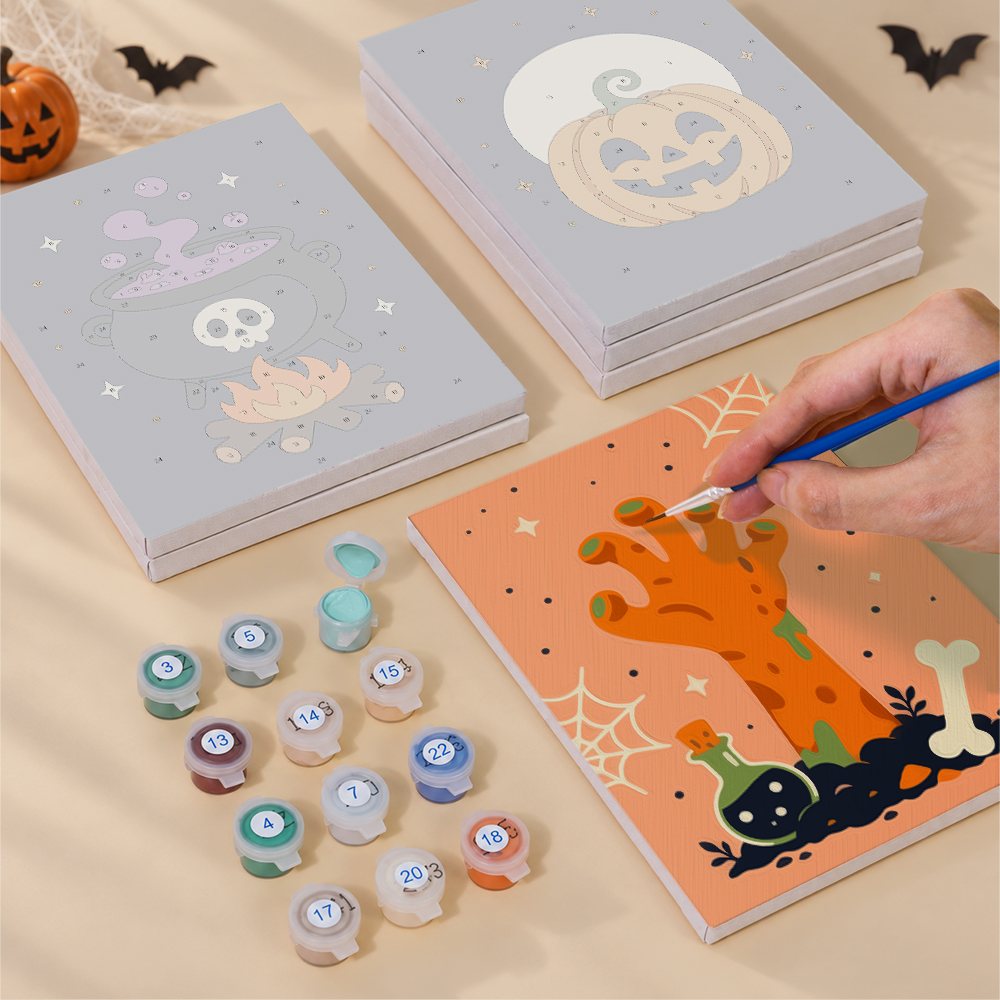 Painting one of the Creepy Classics designs next to a stack of mini canvases