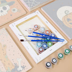 Numbered paint pots and brushes on a pre-stretched Creepy Classics mini canvas