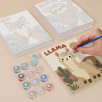 Painting one of the Critter Cards designs next to a stack of mini canvases