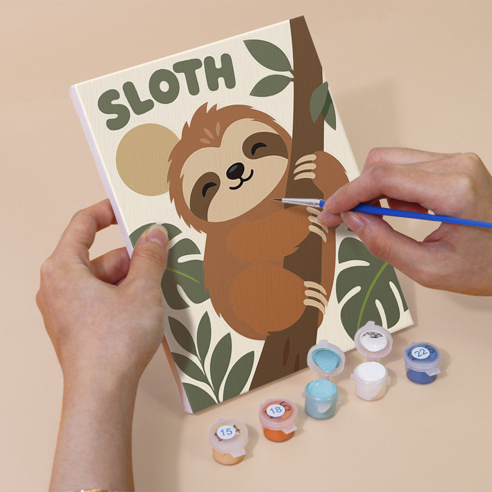 Hand holding a Critter Cards mini canvas while painting the details