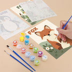 Filling in a Critter Cards mini canvas with numbered acrylic paints and a fine brush