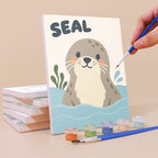 Painting a Critter Cards mini canvas propped up beside numbered acrylic paints