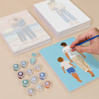 Painting one of the Dad and Me designs next to a stack of mini canvases