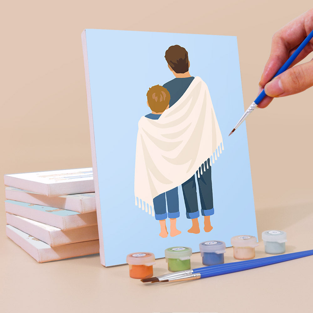 Painting a Dad and Me mini canvas propped up beside numbered acrylic paints