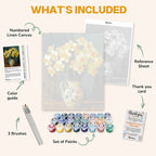What's included in the Daffodils in Porcelain paint by numbers kit: numbered linen canvas, reference sheet, color guide, 24 acrylic paints, 3 brushes and thank you card