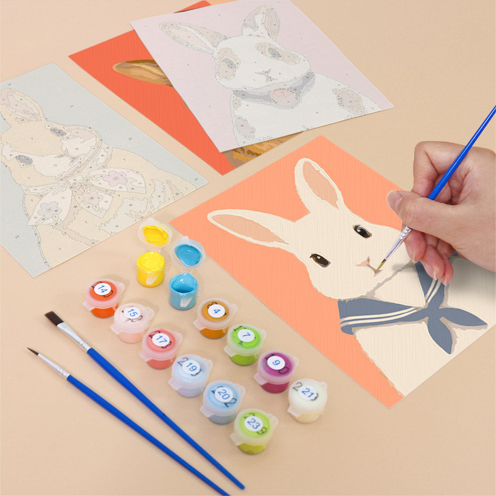 Filling in a Dapper Bunnies mini canvas with numbered acrylic paints and a fine brush