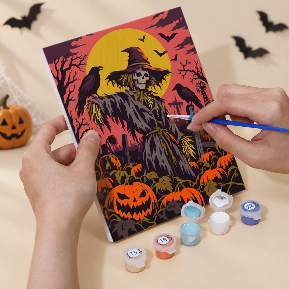 Hand holding a Dark Harvest Folk Art mini canvas while painting the details