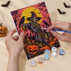 Hand holding a Dark Harvest Folk Art mini canvas while painting the details