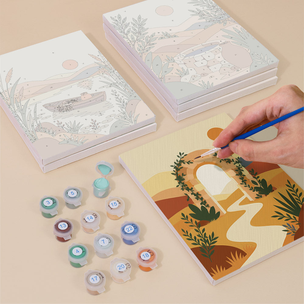 Painting one of the Desert Light designs next to a stack of mini canvases