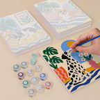 Painting one of the Dogs at Home designs next to a stack of mini canvases