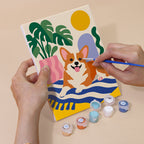 Hand holding a Dogs at Home mini canvas while painting the details