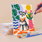 Painting a Dogs at Home mini canvas propped up beside numbered acrylic paints