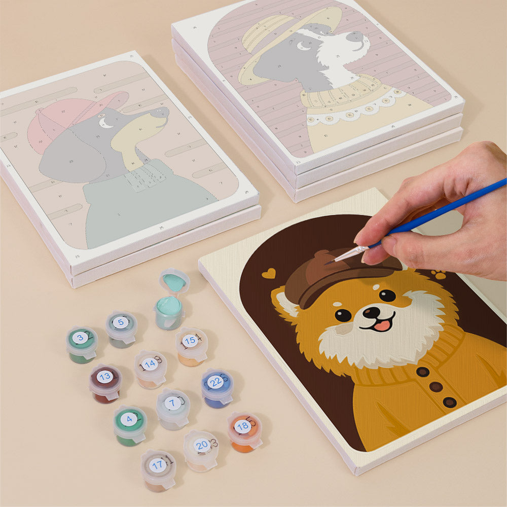 Painting one of the Dogs in Sweaters designs next to a stack of mini canvases