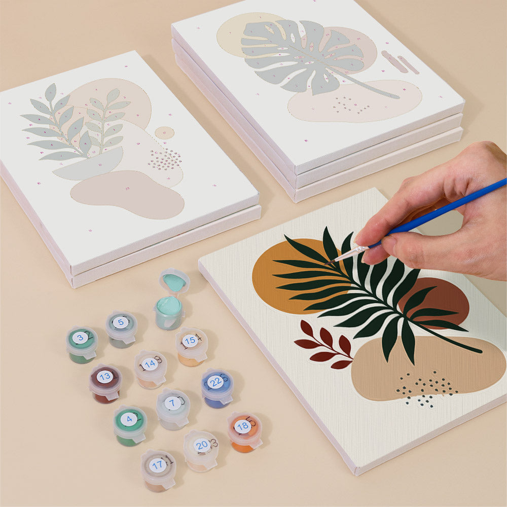 Painting one of the Earthy Leaves designs next to a stack of mini canvases