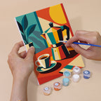 Hand holding an Espresso Bar mini canvas while painting the details