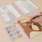 Painting one of the Evening Elegance designs next to a stack of mini canvases