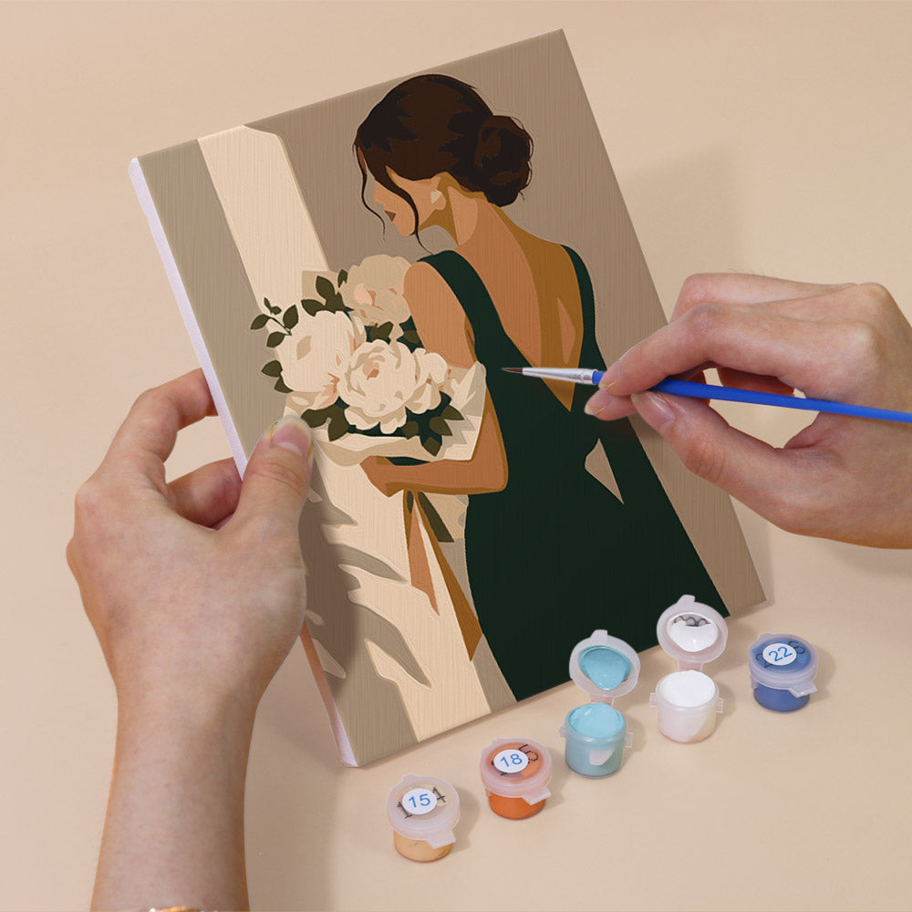 Hand holding an Evening Elegance mini canvas while painting the details