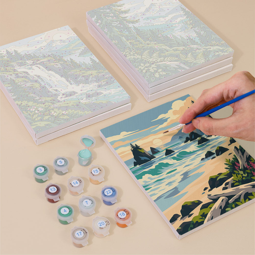 Painting one of the Evergreen Coast designs next to a stack of mini canvases