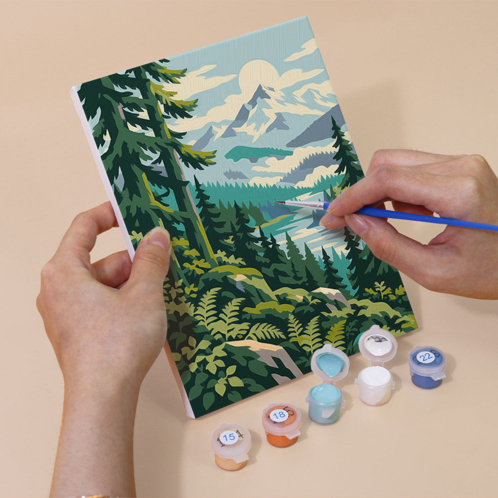 Hand holding an Evergreen Coast mini canvas while painting the details