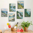 Six finished Evergreen Coast mini paintings hung on a wall above a table