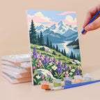 Painting an Evergreen Coast mini canvas propped up beside numbered acrylic paints