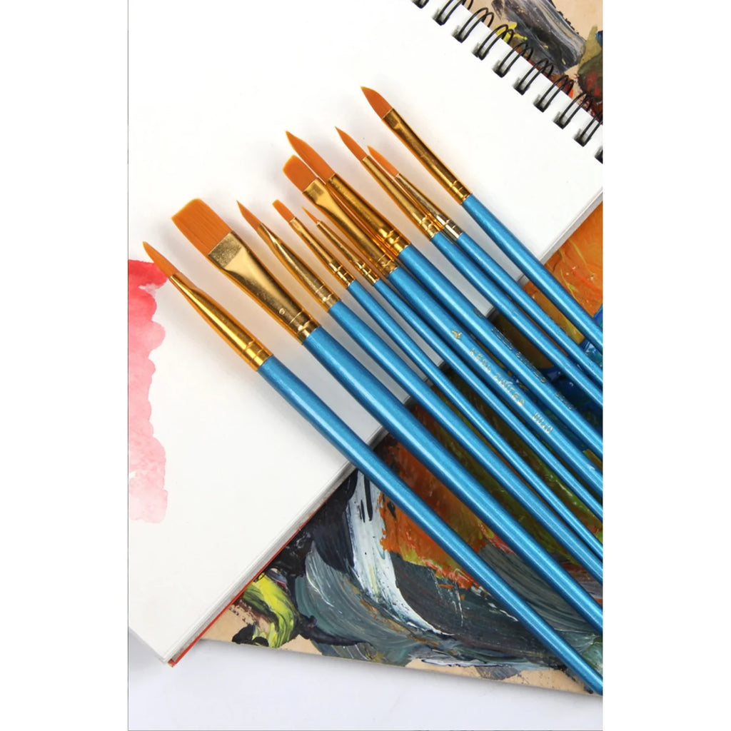 Blue-handled paint by numbers brush set laid on a sketchbook with acrylic paint