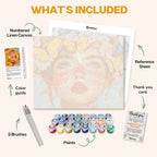 What's included in the Eyes of Innocence paint by numbers kit: numbered linen canvas, reference sheet, color guide, 24 acrylic paints, 3 brushes and thank you card