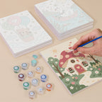 Painting one of the Fairytale Dreams designs next to a stack of mini canvases