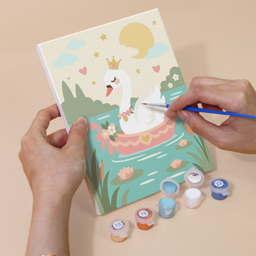 Hand holding a Fairytale Dreams mini canvas while painting the details