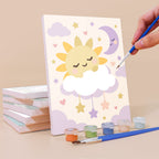 Painting a Fairytale Dreams mini canvas propped up beside numbered acrylic paints