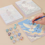 Painting one of the Faith & Grace designs next to a stack of mini canvases