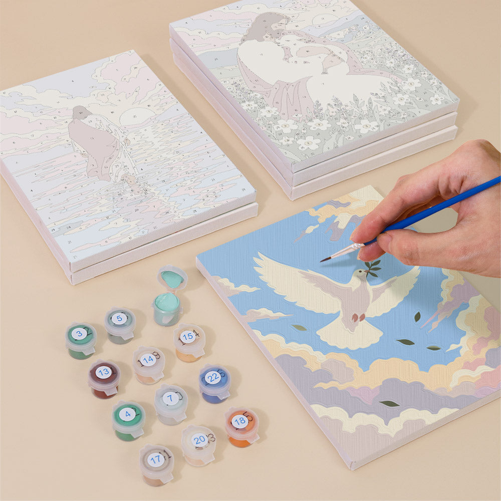 Painting one of the Faith & Grace designs next to a stack of mini canvases