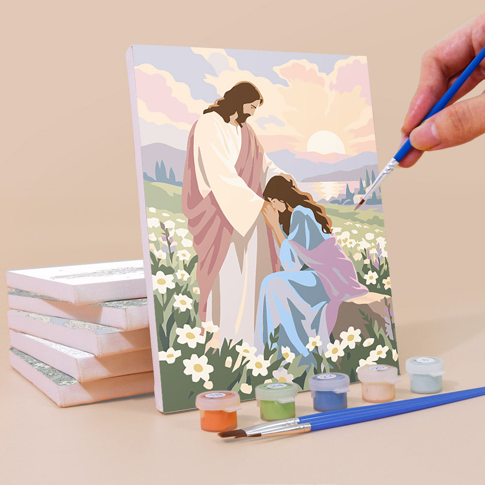 Painting a Faith & Grace mini canvas propped up beside numbered acrylic paints