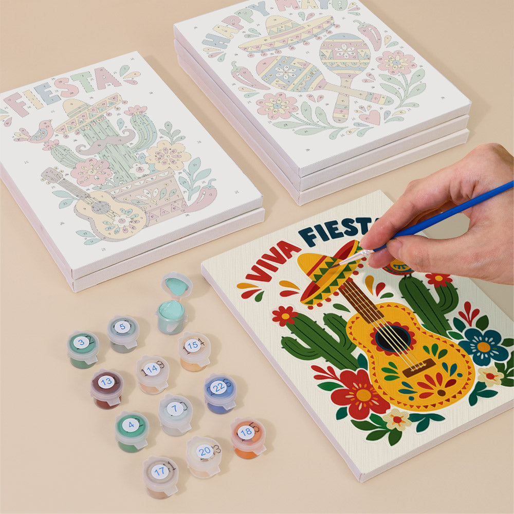Painting one of the Fiesta Time designs next to a stack of mini canvases