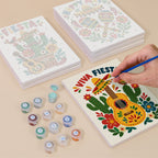 Painting one of the Fiesta Time designs next to a stack of mini canvases