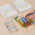 Painting one of the Flower Box Windows designs next to a stack of mini canvases